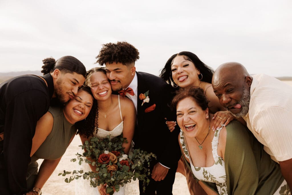 bridal party smiling at the camera