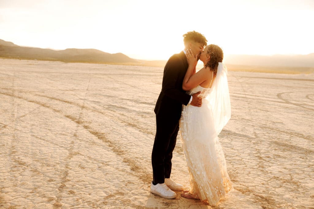 bride and groom kissing at the dry lake bed