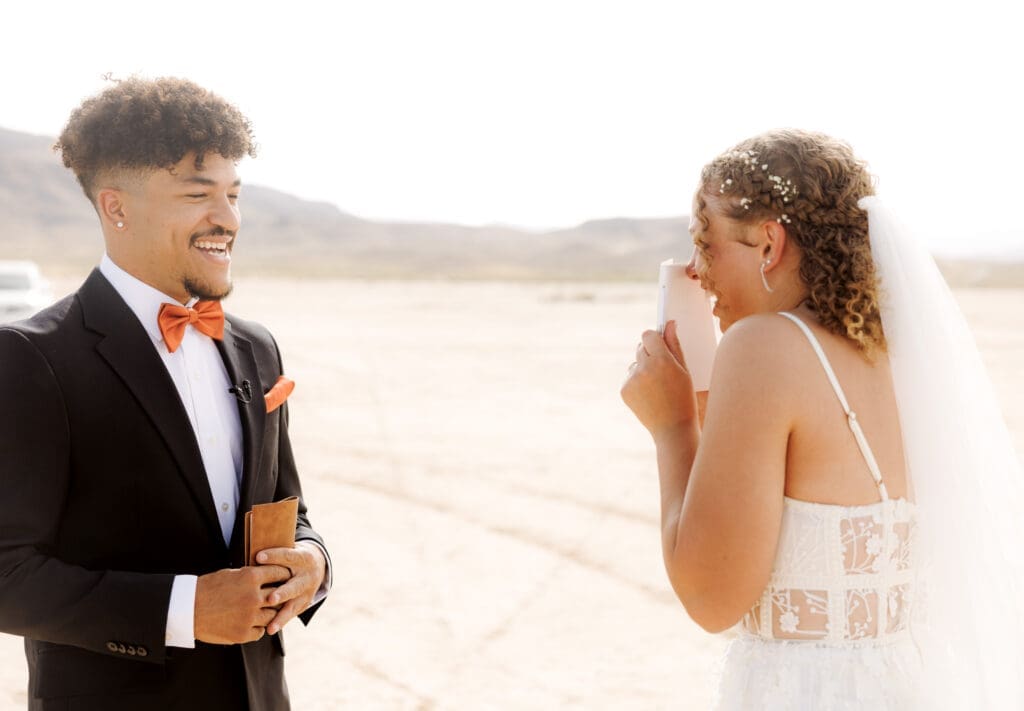 bride and groom reading vows to each other