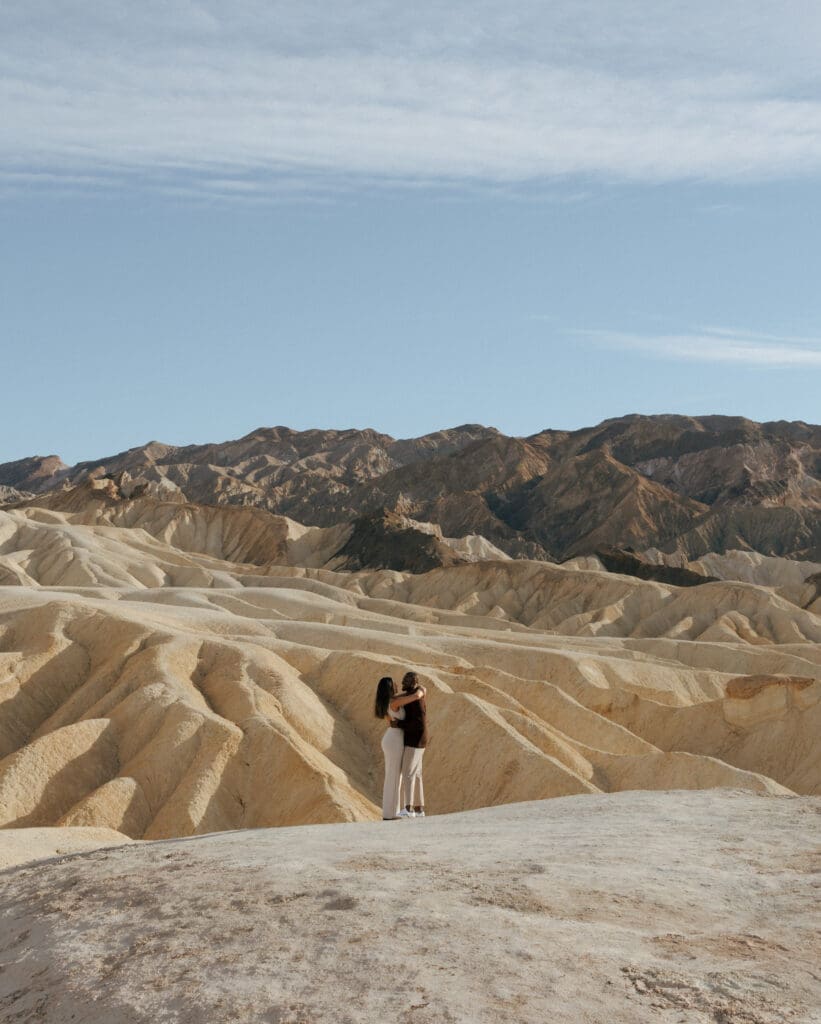 couple hugging on edge of cliff