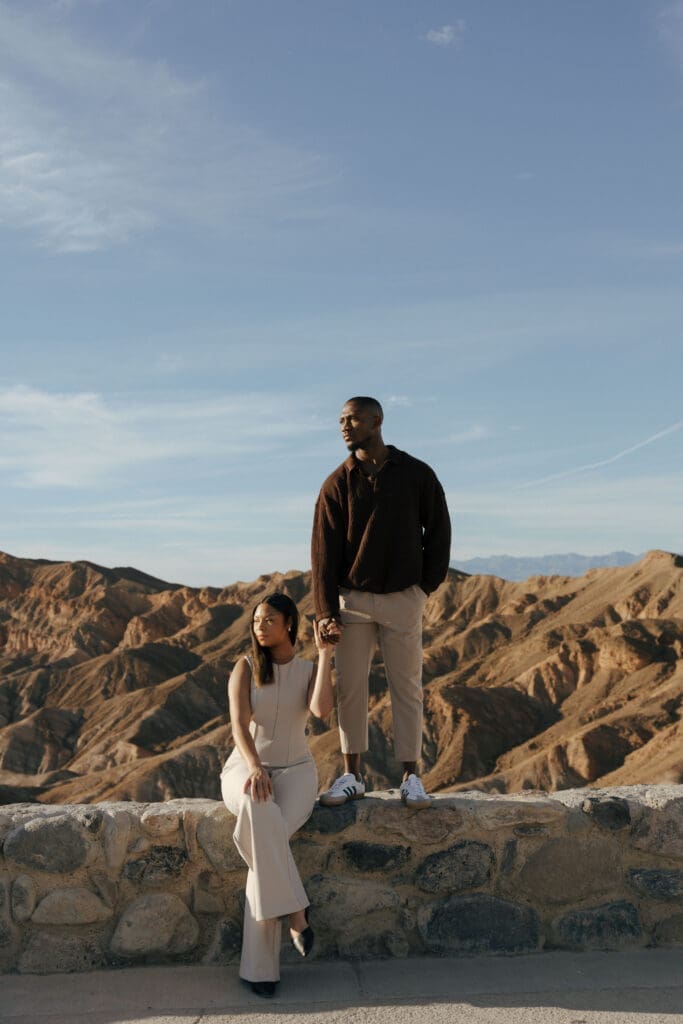 girl sitting and guy standing on rock
