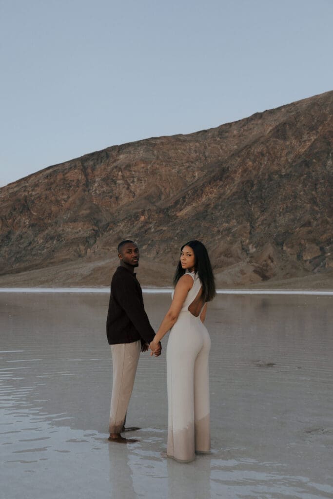 couple holding hands looking over shoulder