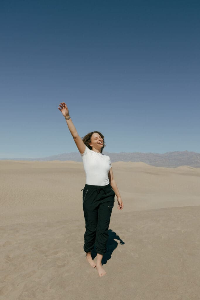 woman playing in the sand dunes