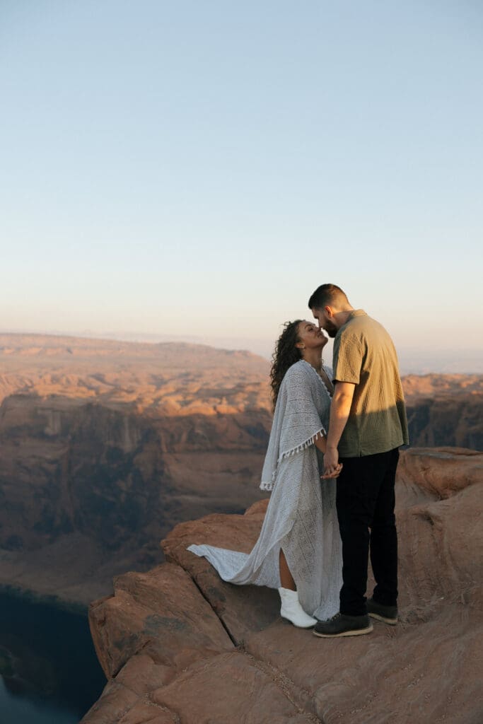 couple kissing near cliff