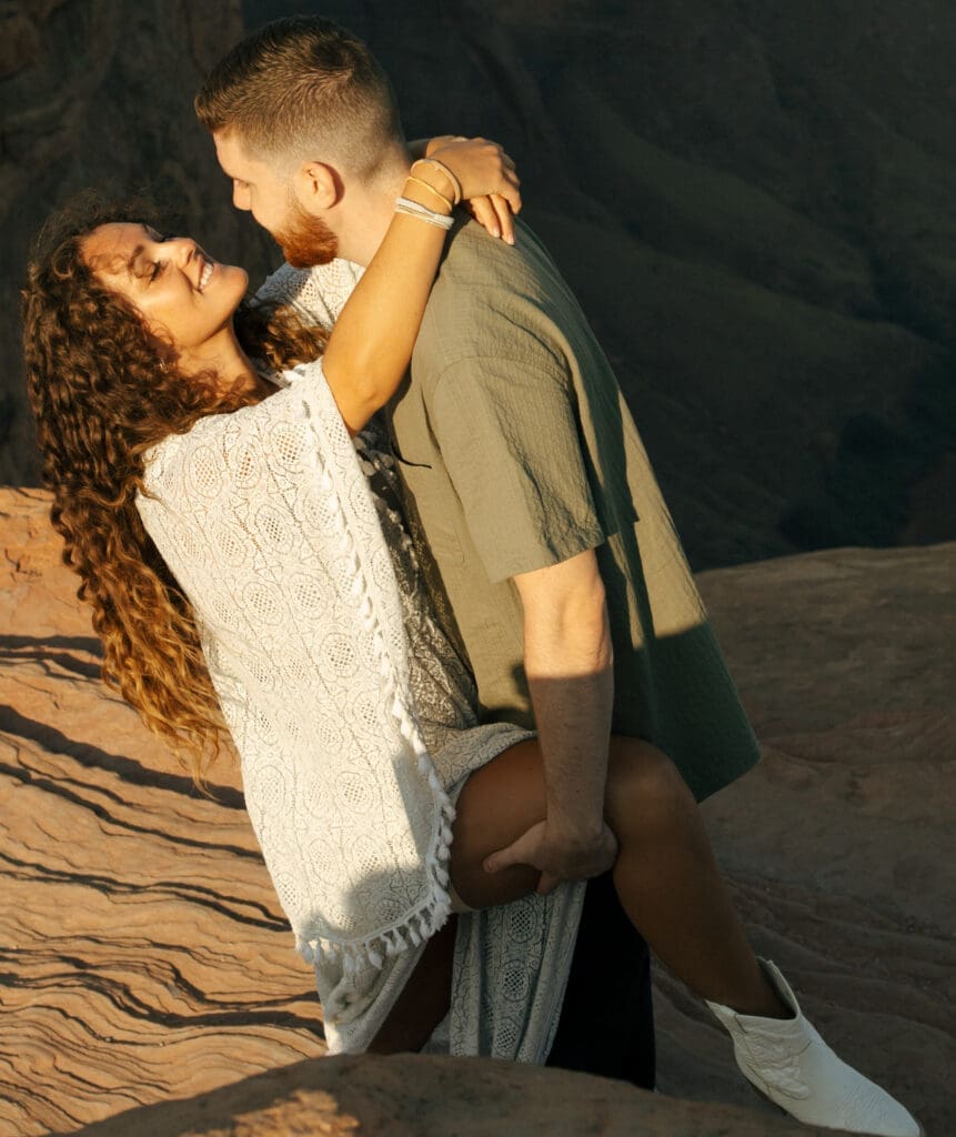 couple hugging on red rocks