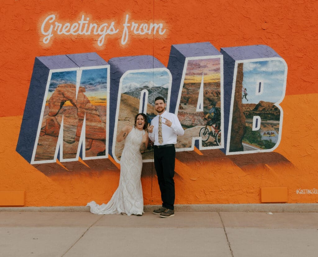 couple in fron of the moab sign