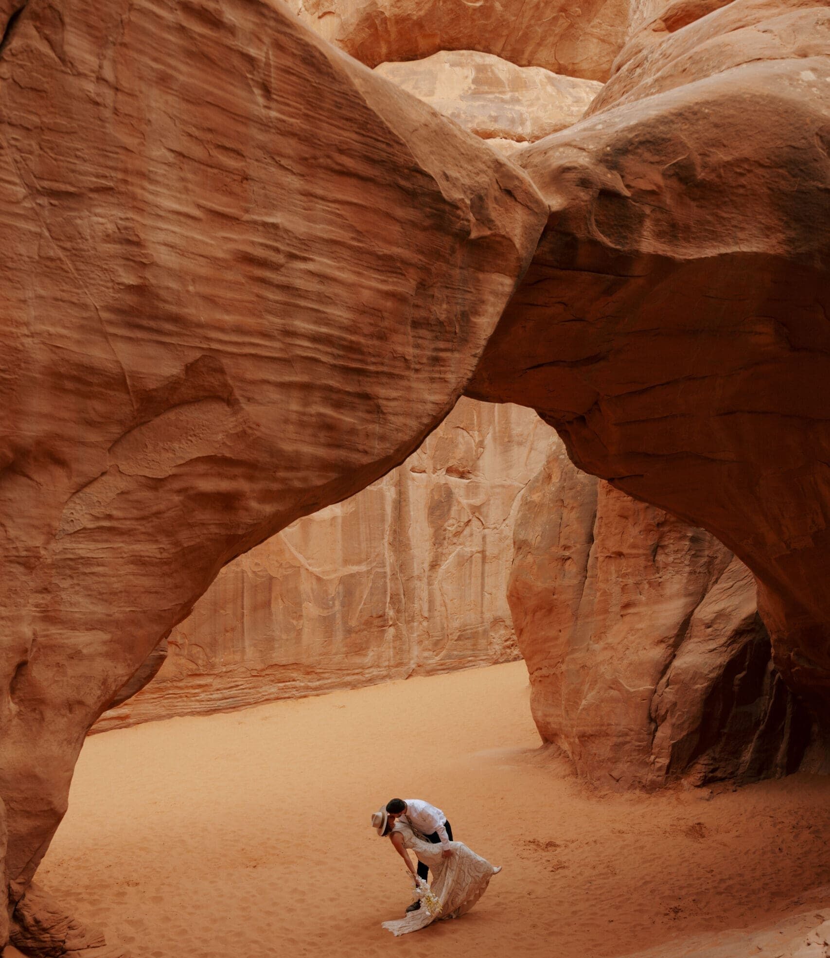 bride and groom kissing in arches national park