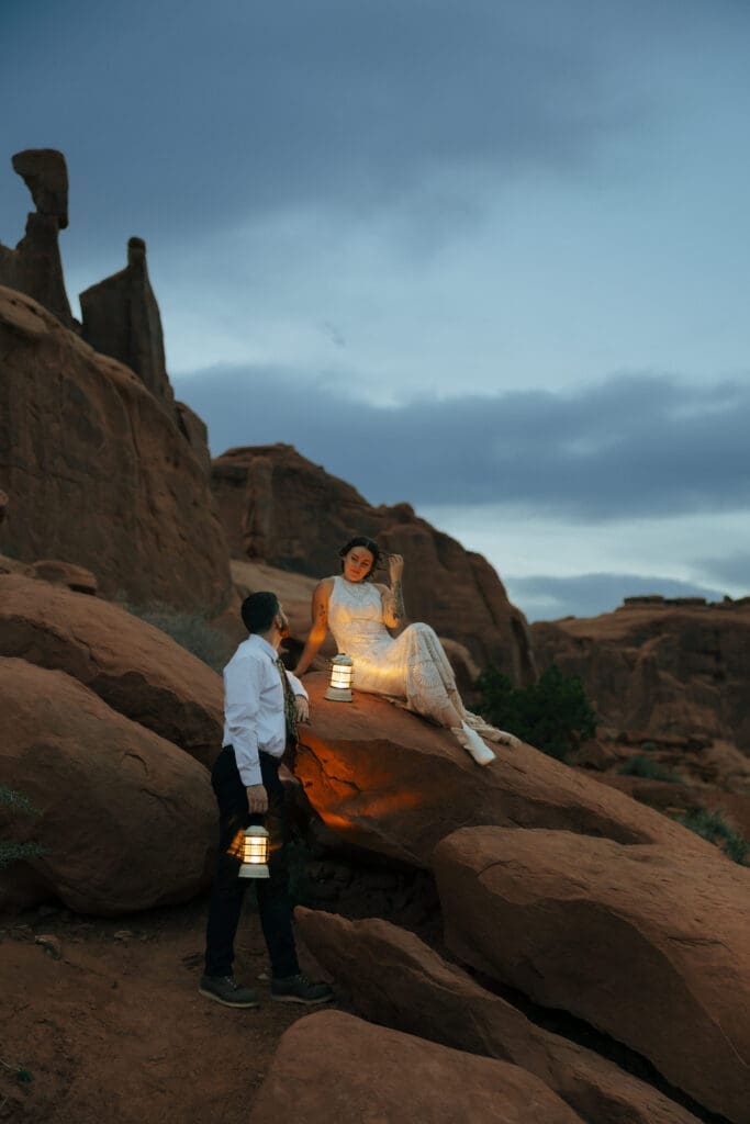 bride and groom looking at each other with lanterns