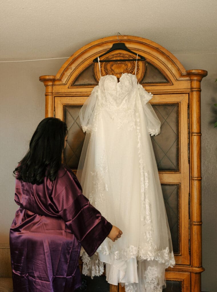 bride looking at her wedding dress