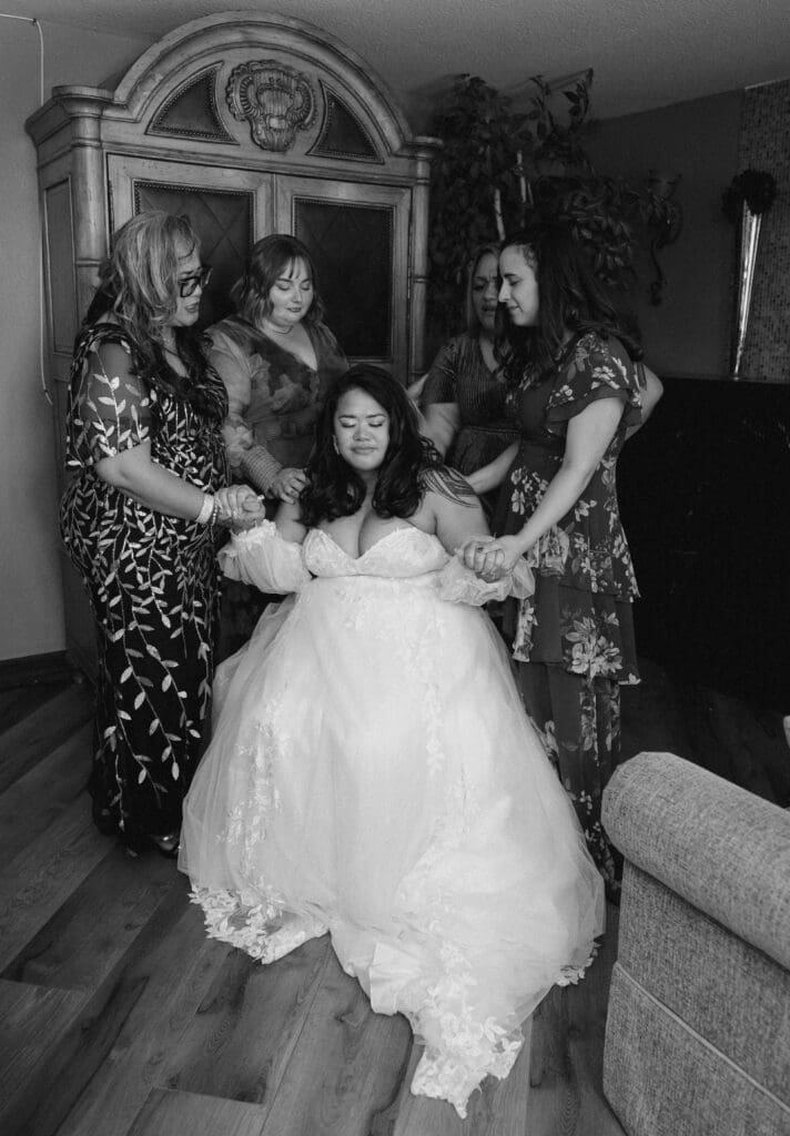 bride with bridesmaids praying before ceremony