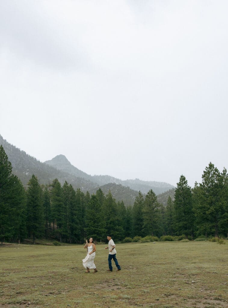 couple playing tag in forrest