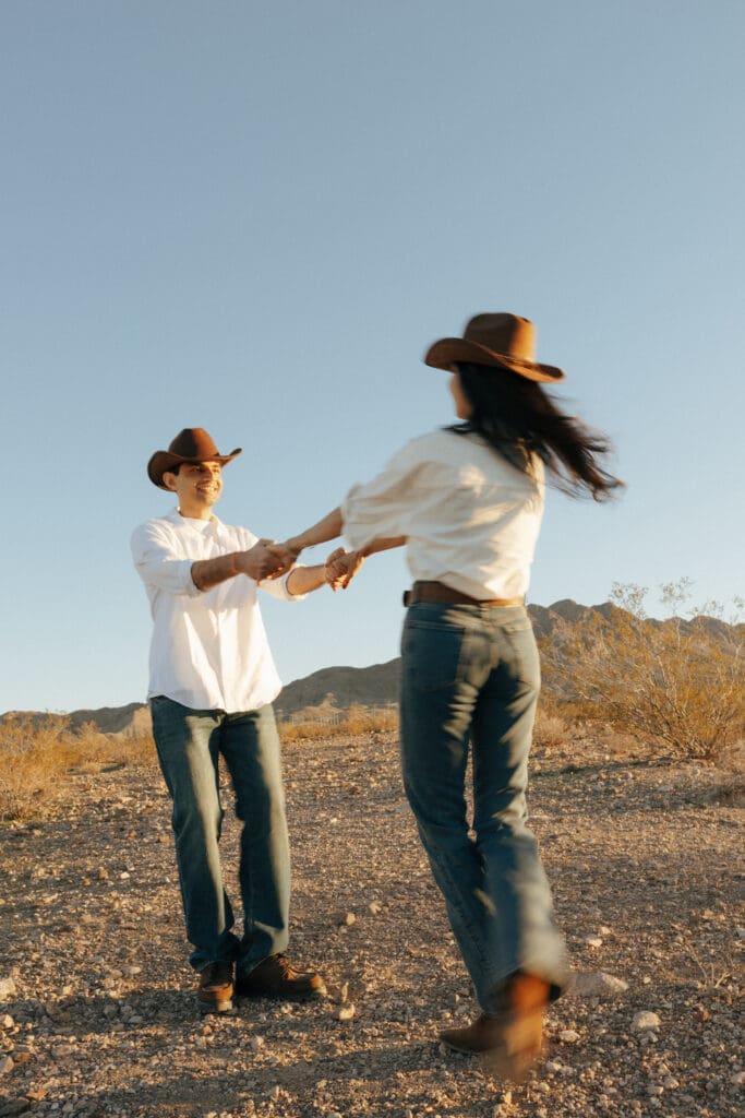 couple laughing in the desert for western engagement photos in vegas