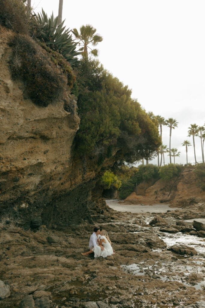couple sitting together at a beach in california