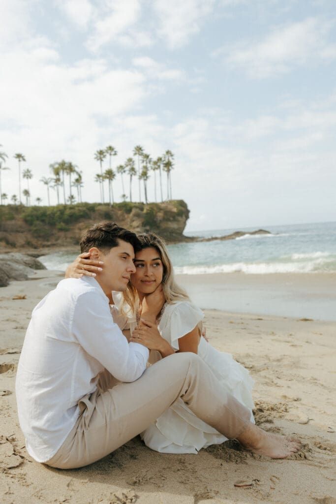 couple sitting down together at crescent bay beach