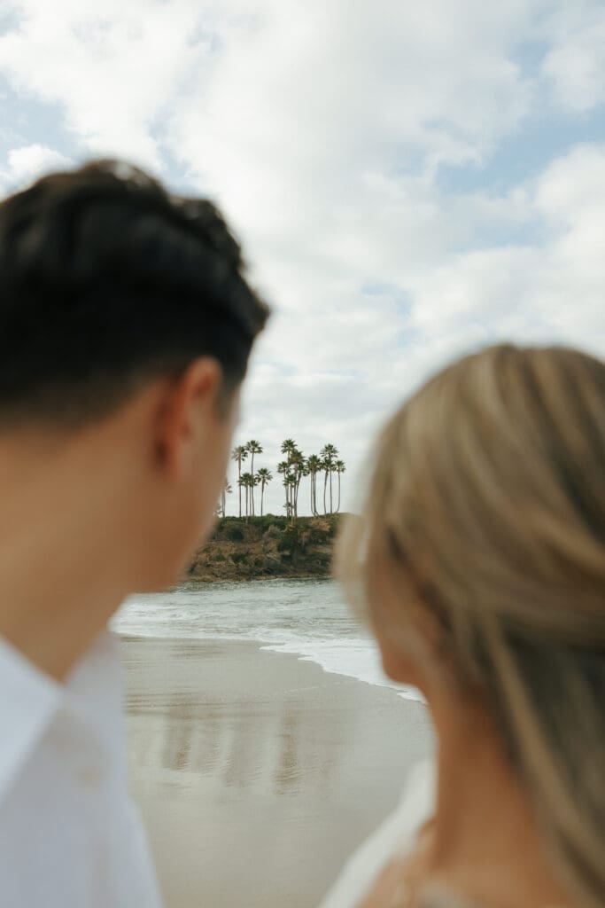 couple looking at the landscape of crescent bay beach