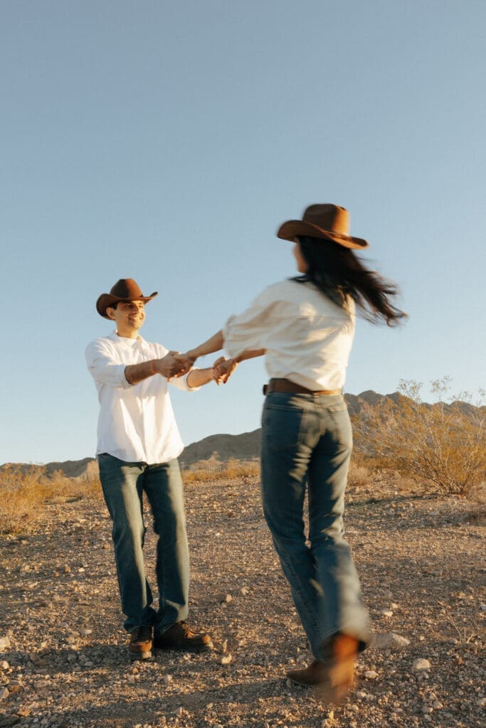couple laughing in the desert for western engagement photos in vegas