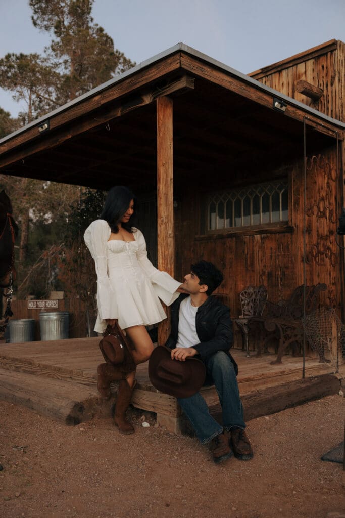 couple posing for western engagement photos in vegas at hold your horses las vegas