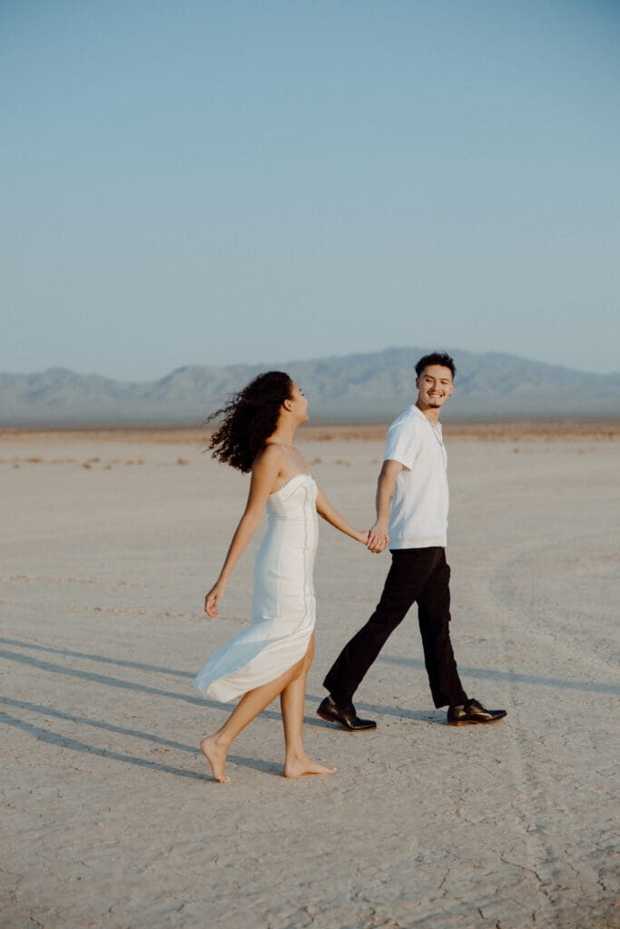 couple holding hands at the dry lake bed in las vegas