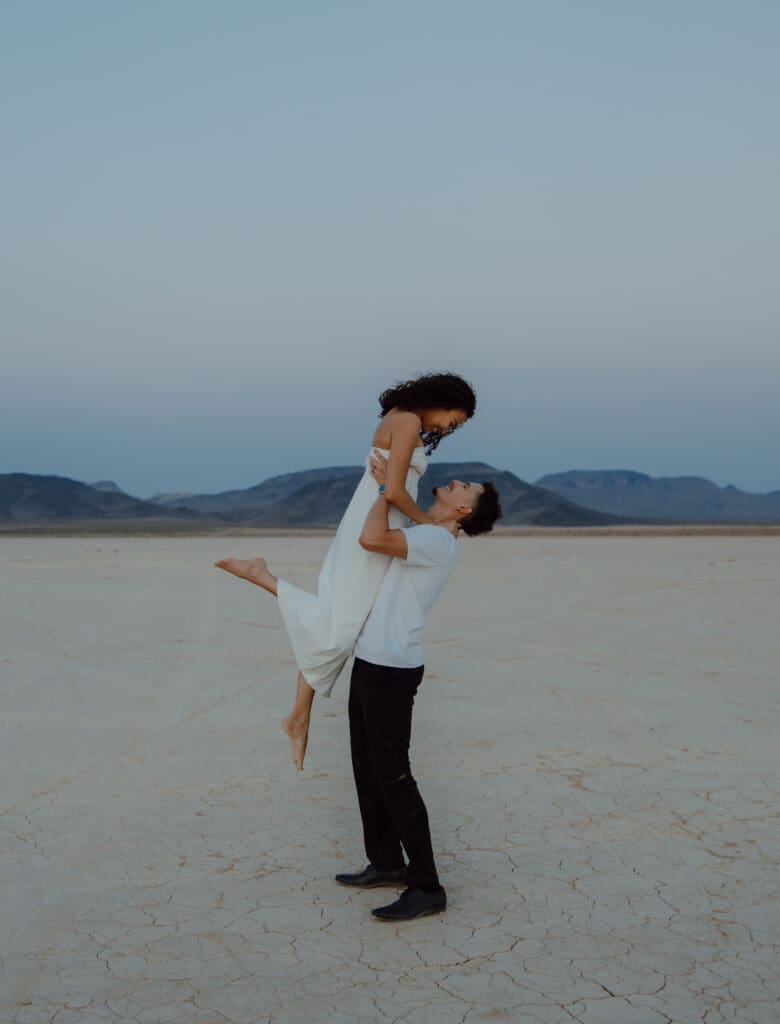groom picking up bride during las vegas elopement