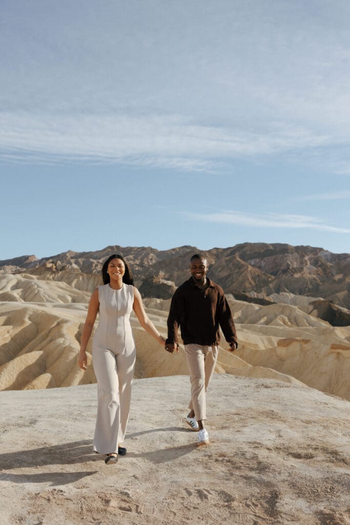 couple walking towards camera at zabriskie point