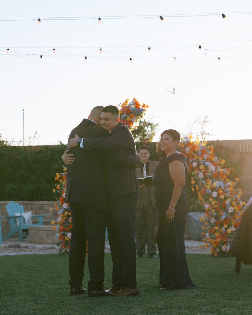 groom hugging father as going to the altar for wedding
