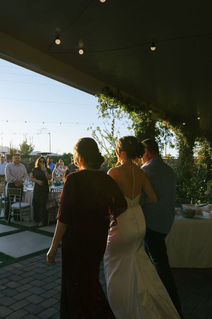 parents walking bride down aisle