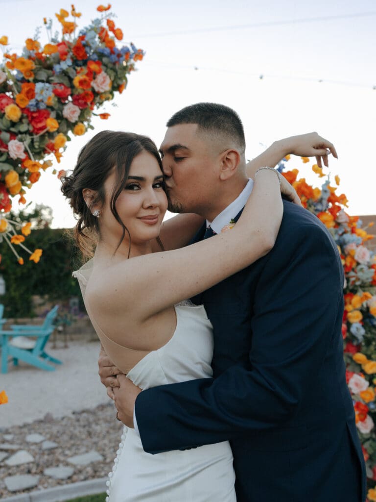 groom kissing brides forehead