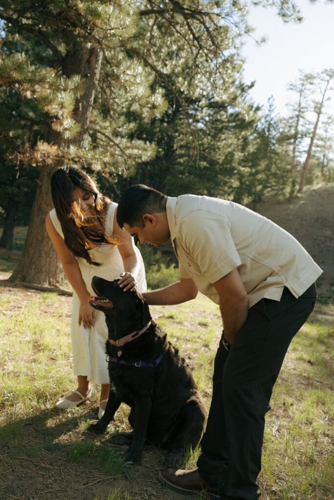 couple playing with their dog during their las vegas engagement photos in mt charleston