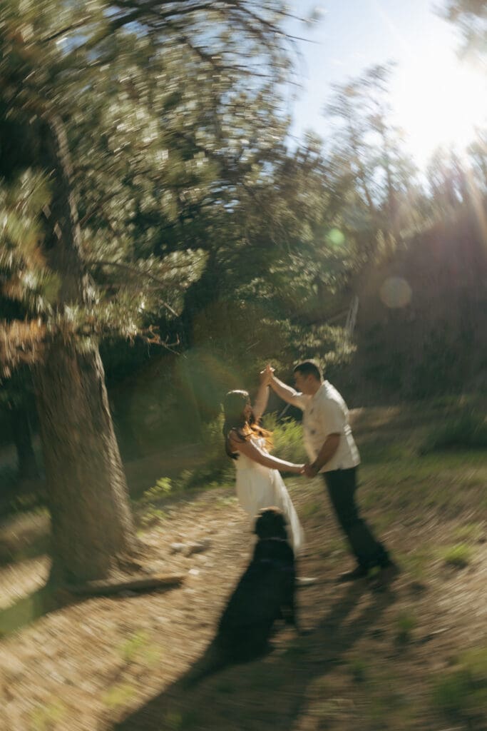 shutter drag image of couple playing with their dog in las vegas