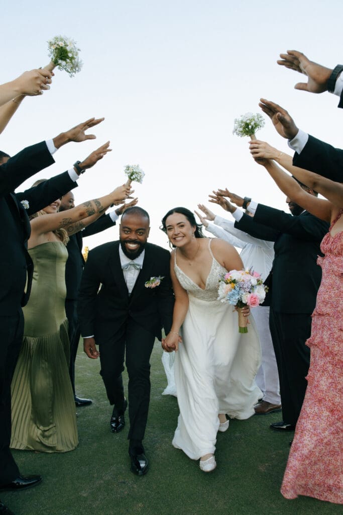 bride and groom running through wedding party tunnel in las vegas