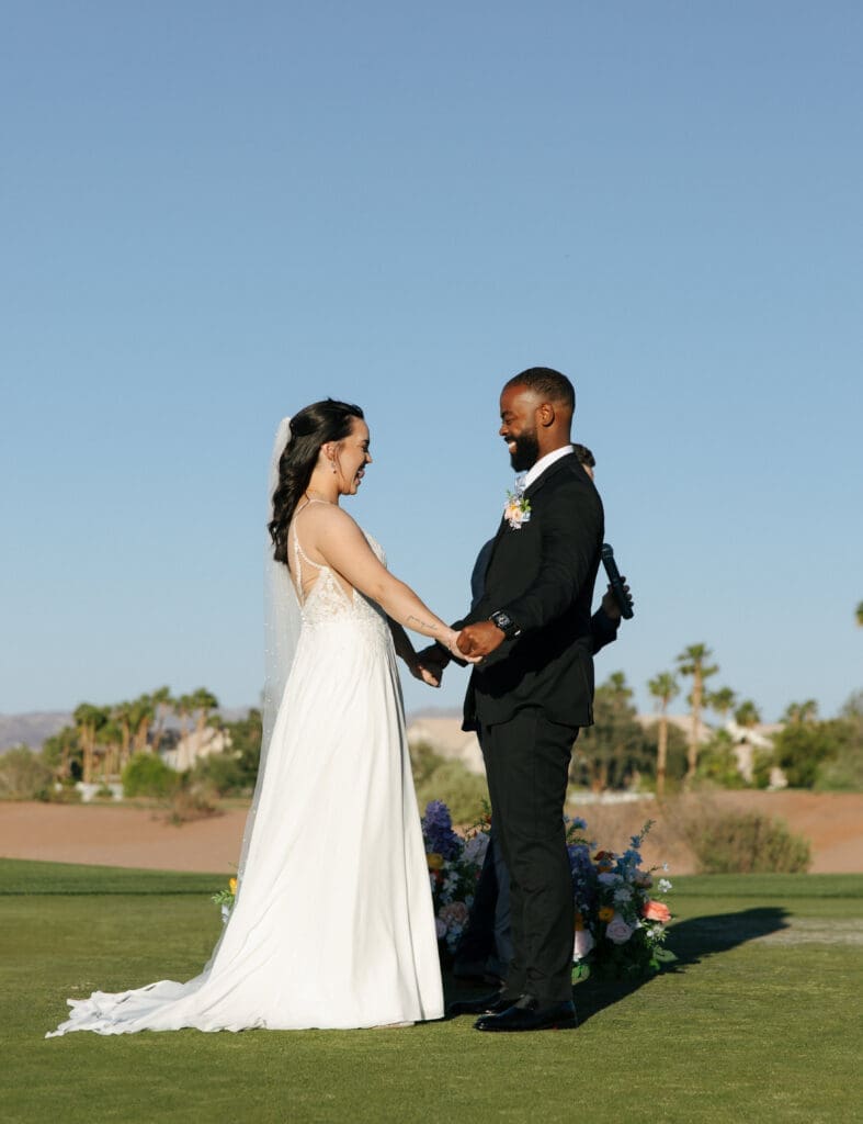 bride and groom running through wedding party tunnel in las vegas