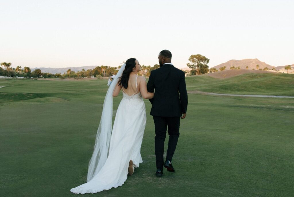 bride and groom walking hand in hand at golf course wedding venue in las vegas