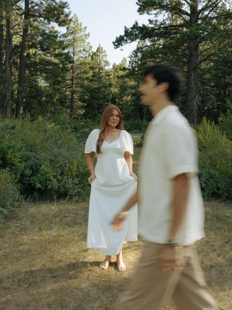 man walking past woman during engagement session in las vegas