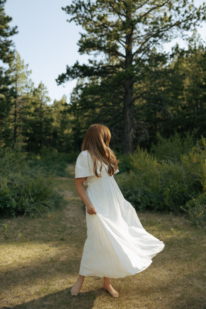 woman twirling her engagement dress in the nevada forest