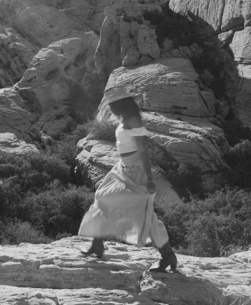 black and white movement image of a woman walking