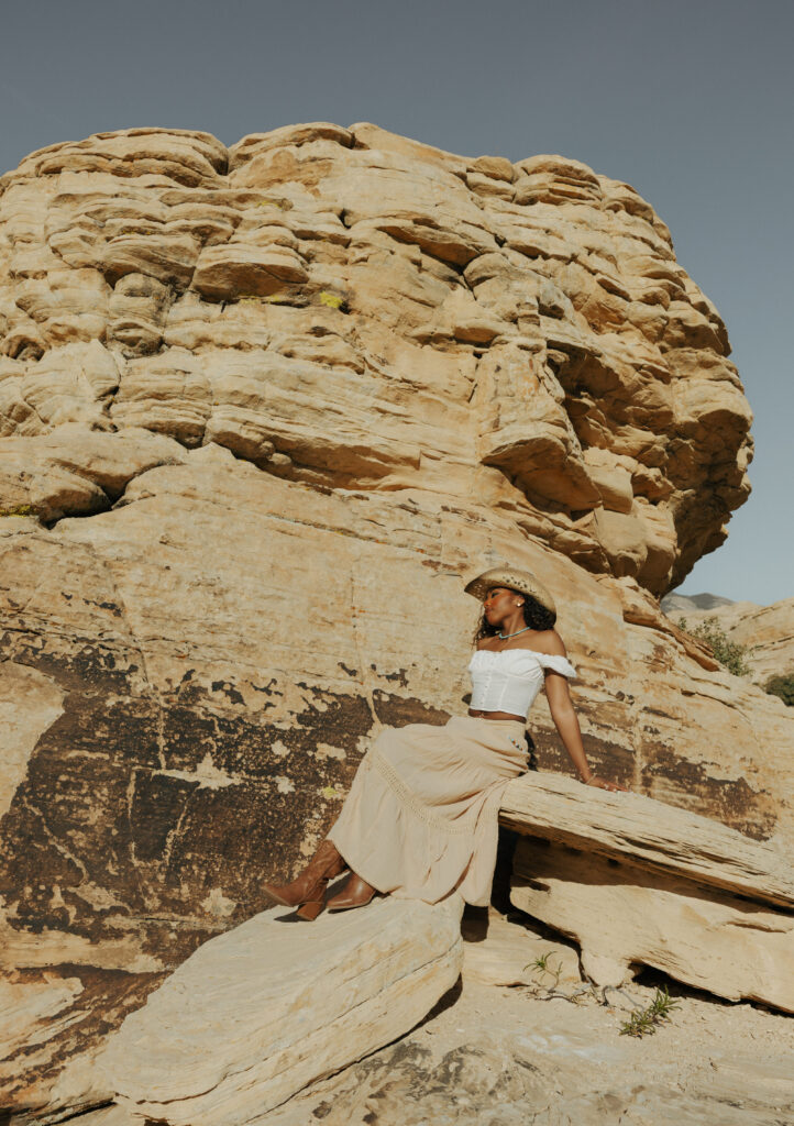 woman sitting on red rocks in las vegas nevada