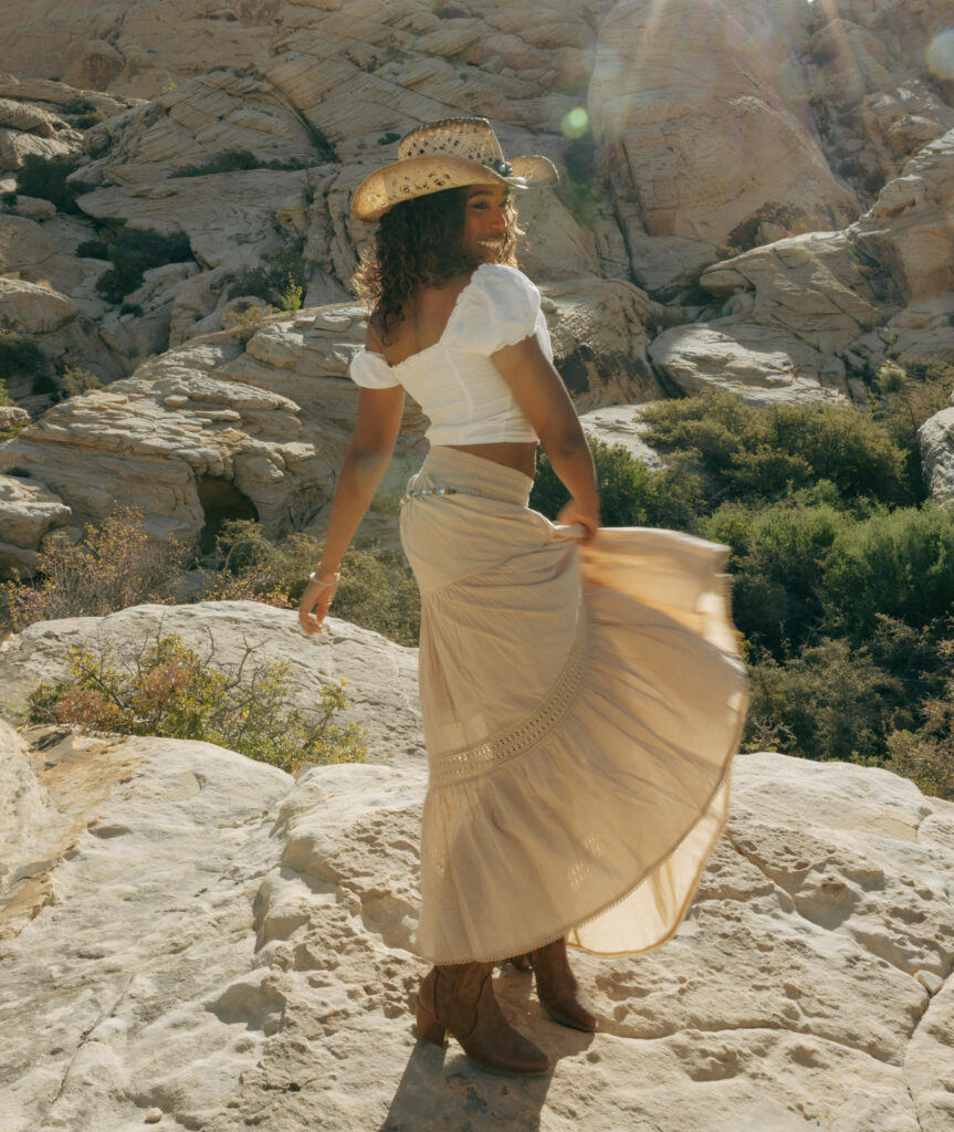 woman playing with skirt during a desert boho portrait session in las vegas
