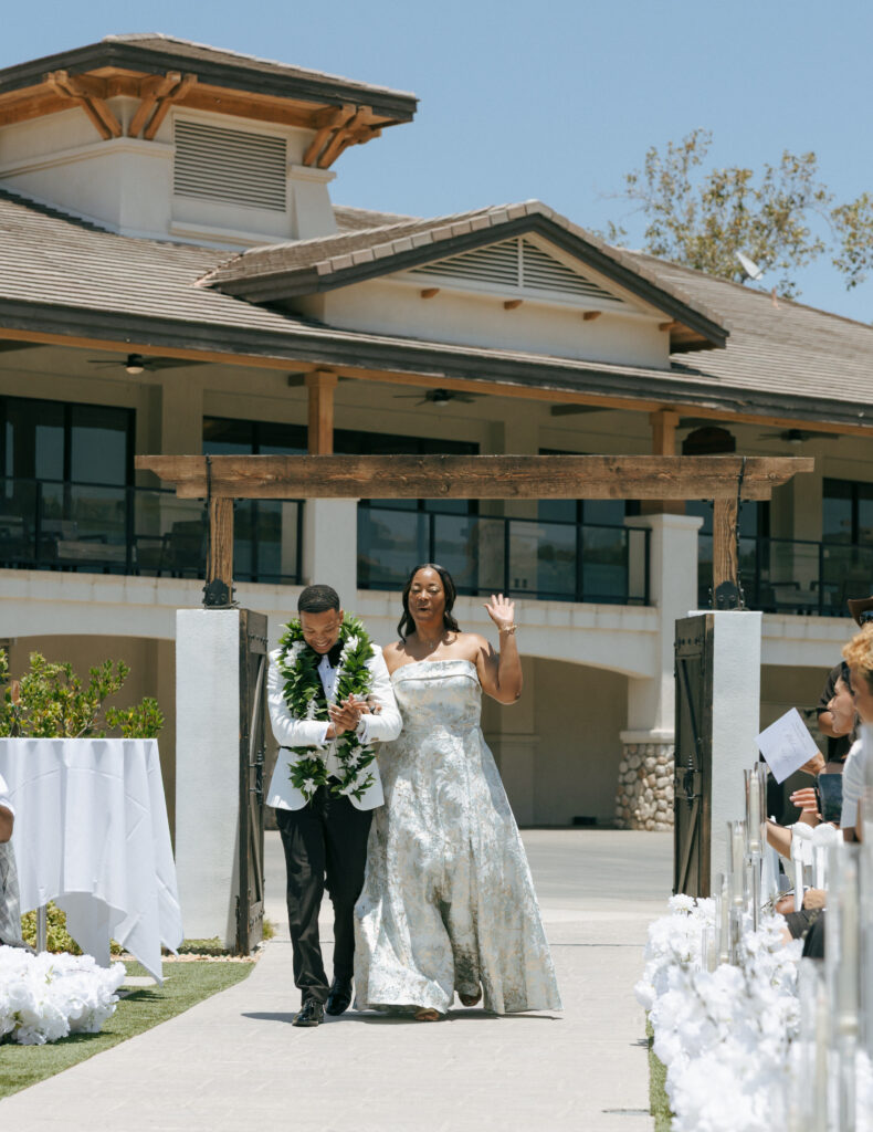groom and mom walking down the aisle at eagle glen golf club