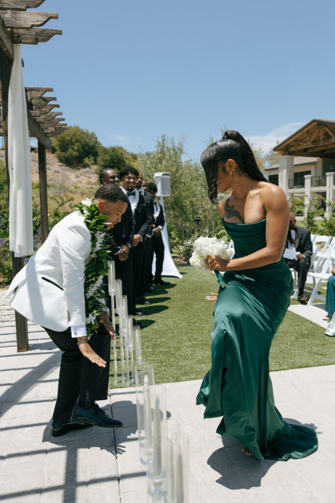 groom and bridesmaid handshake at altar