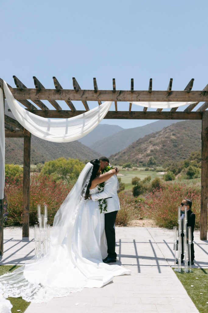 bride and groom kissing at eagle glen golf club wedding ceremony