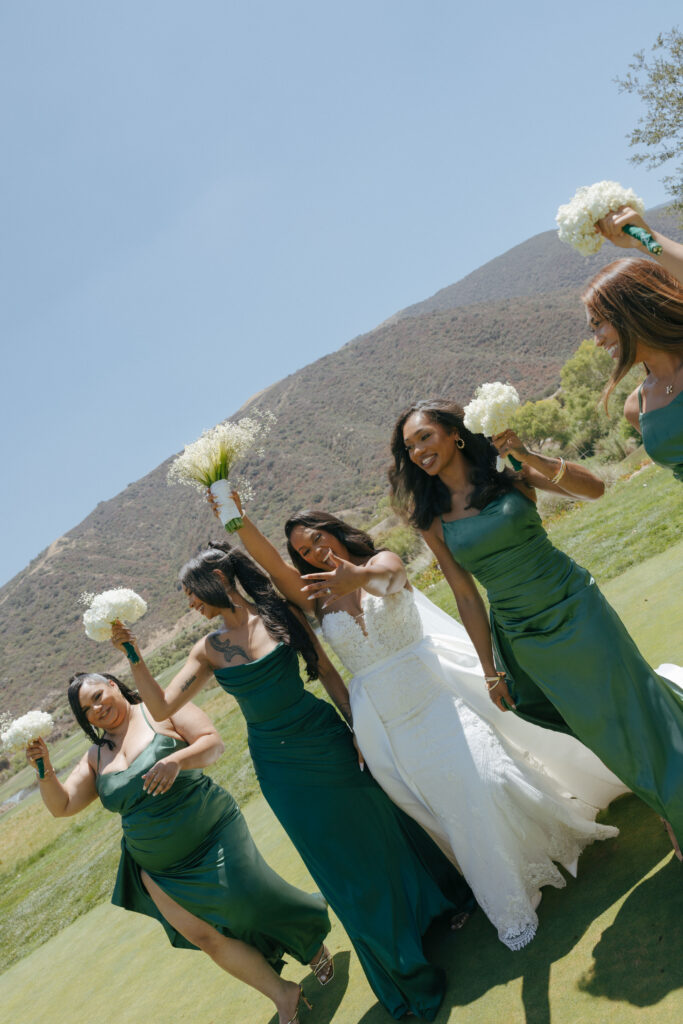 bride and bridesmaid walking laughing