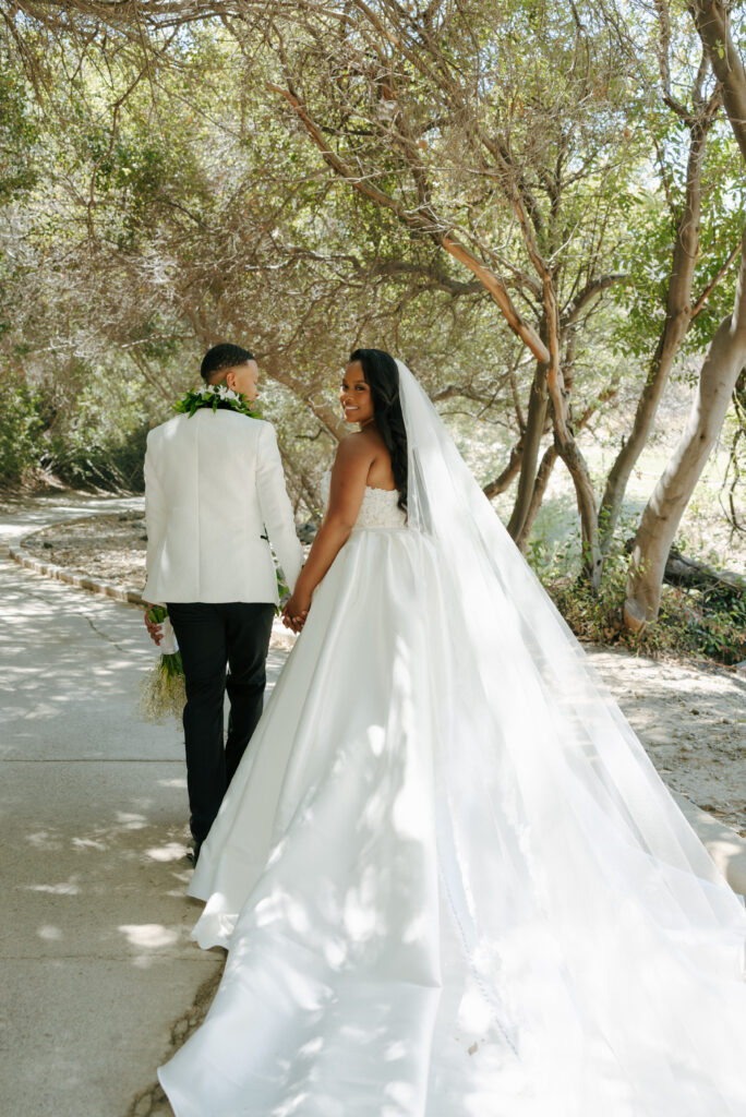 bride and groom walking holding hands