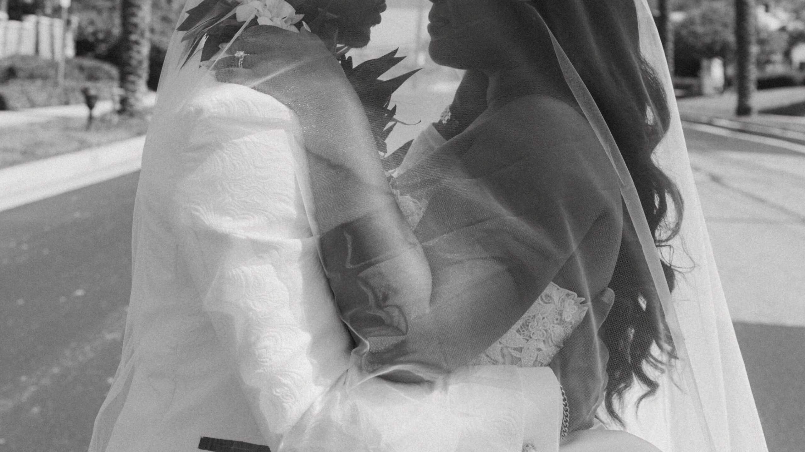 bride and groom under veil