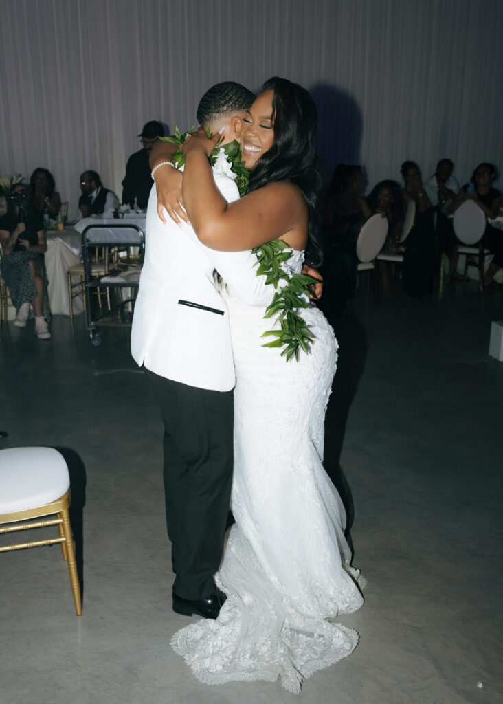 bride and groom hugging at reception