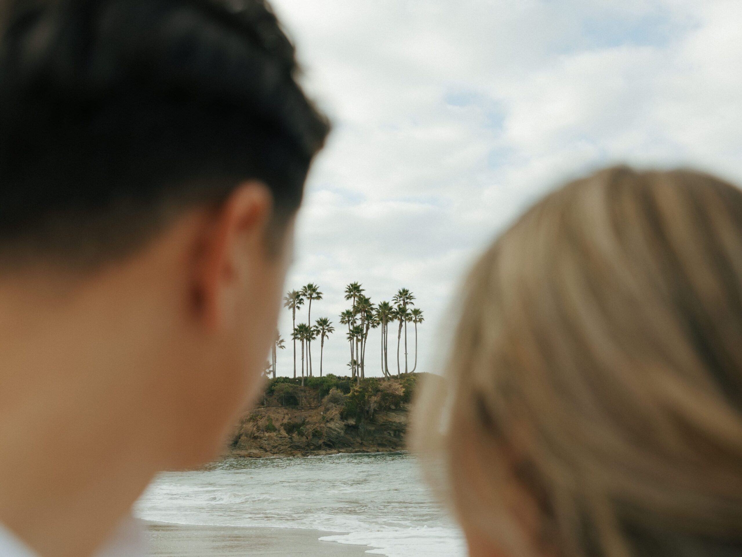 couple looking at the landscape of crescent bay beach