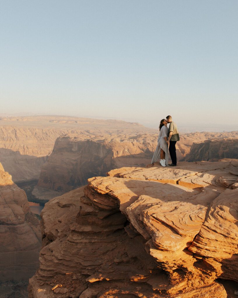 couple kissing at the edge of a cliff in arizona during their elopement