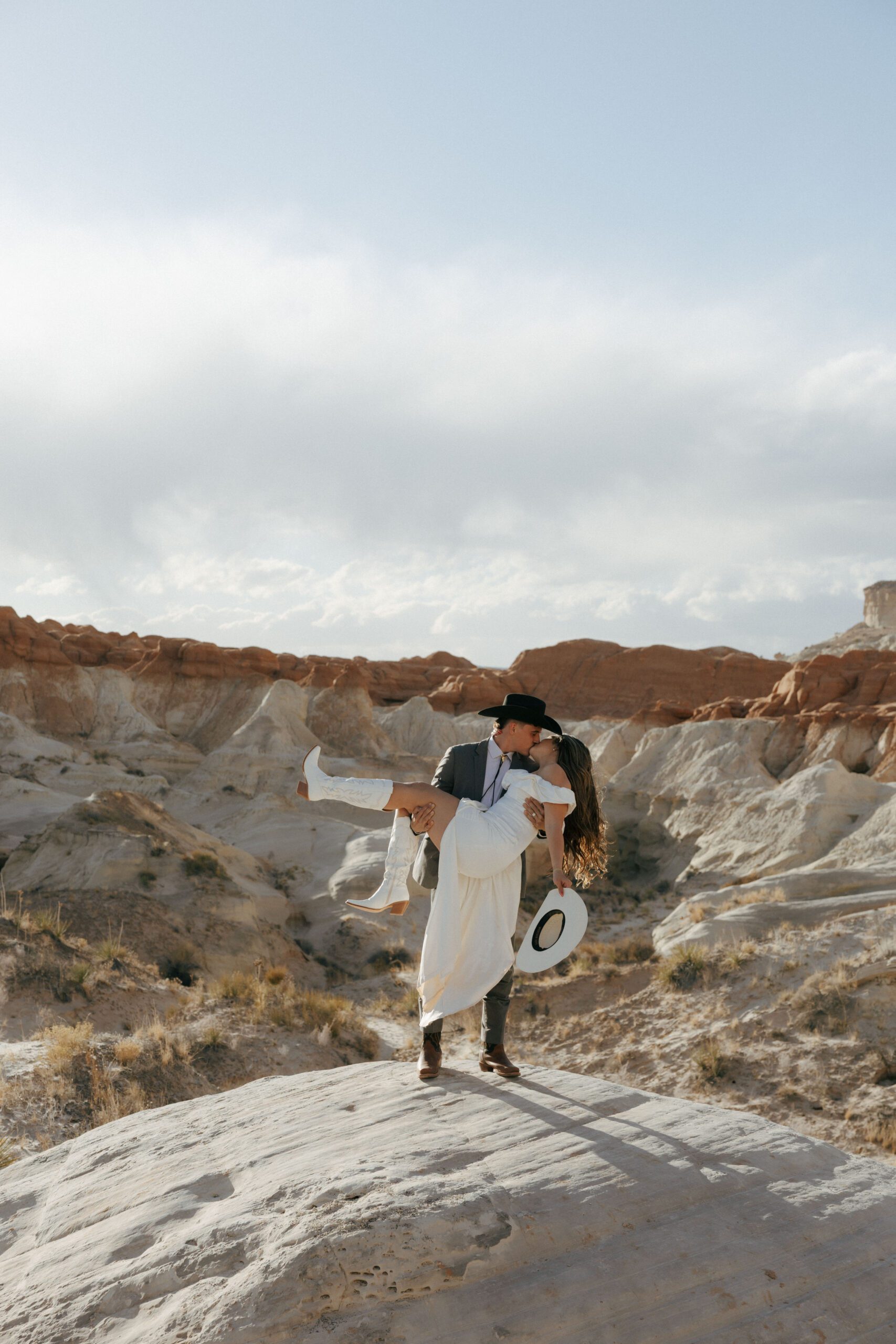 groom picking bride up kissing for their adventure elopement in utah