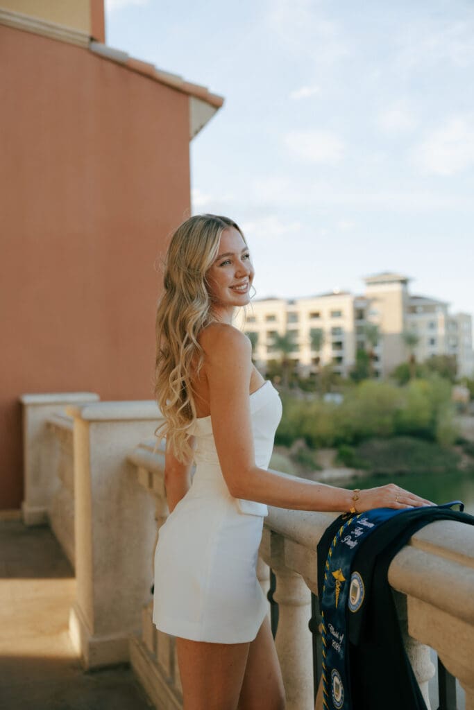 woman smiling over the balcony at lake las vegas