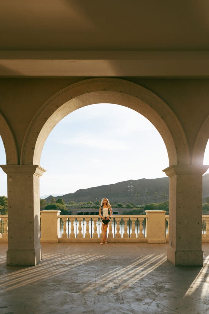 woman taking graduation photos at lake las vegas