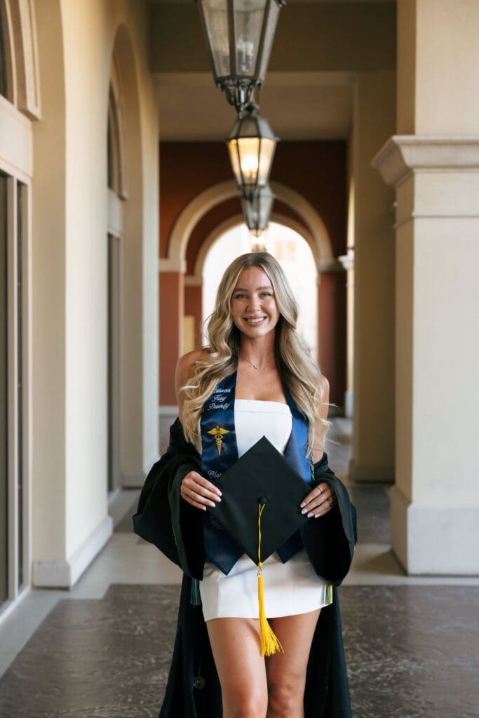 woman smiling with cap and gown during grad photos in las vegas